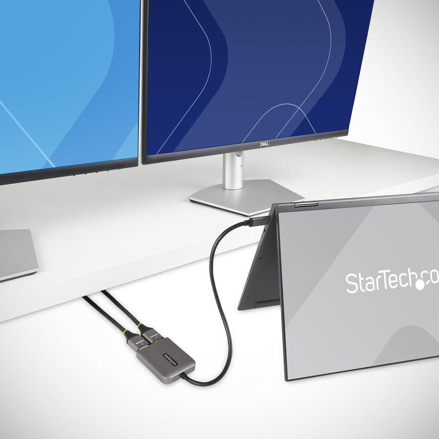 A StarTech.com USB-C to Dual HDMI Adapter with a gray body and a long black cable ending in two HDMI connectors.